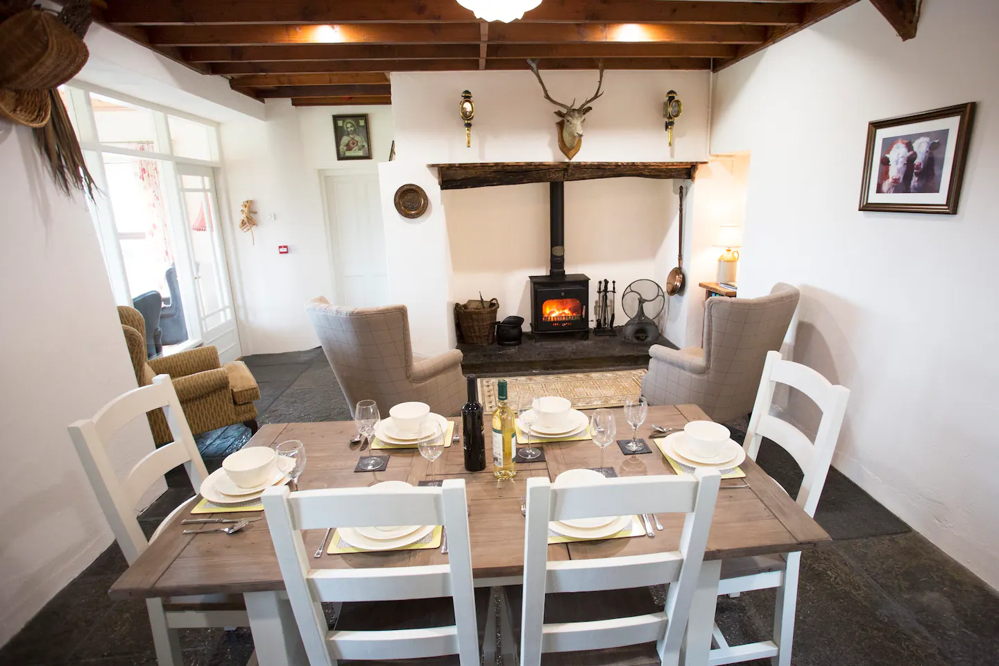 The kitchen table and fireplace of Mary Kates Self Catering Farm House